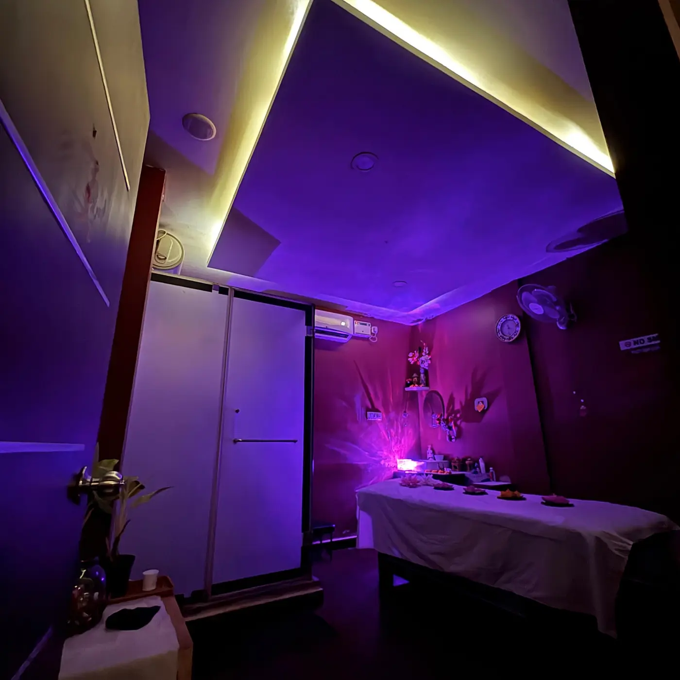 Dimly lit private spa suite with ambient violet lighting at Ocean Leaf Premium Spa
